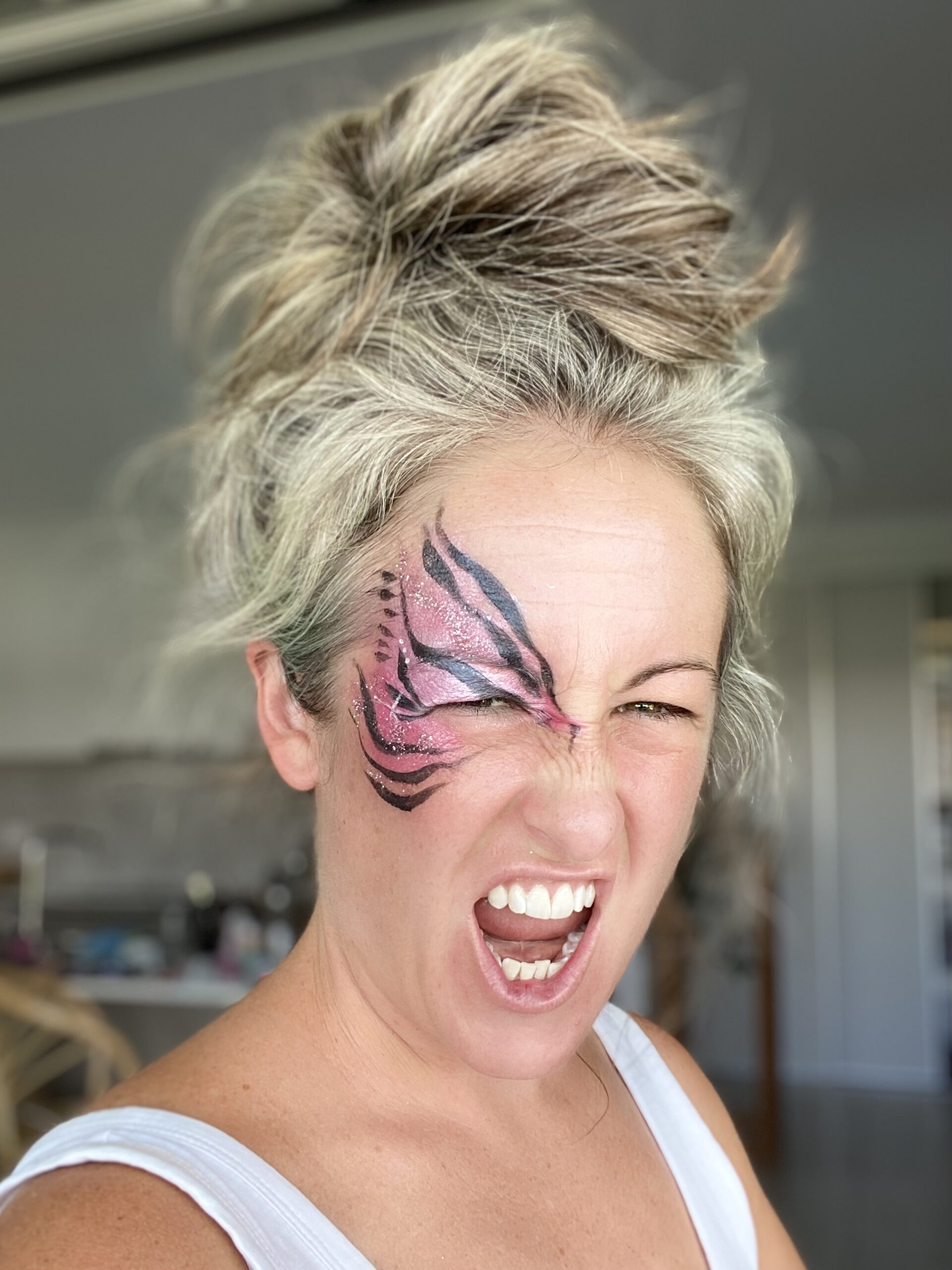 Woman with pink tiger facepaint